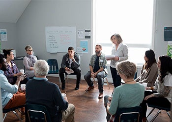 Grupo de pessoas reunidas em uma sala, simbolizando a acessibilidade e os benefícios da terapia para todos
